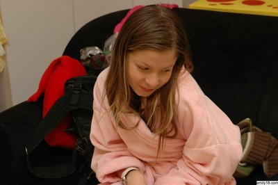 Seductive ill-lit teen girl removes bathrobe